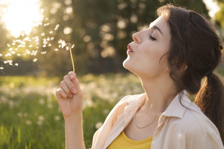 close-up-woman-with-dandelion-outdoors