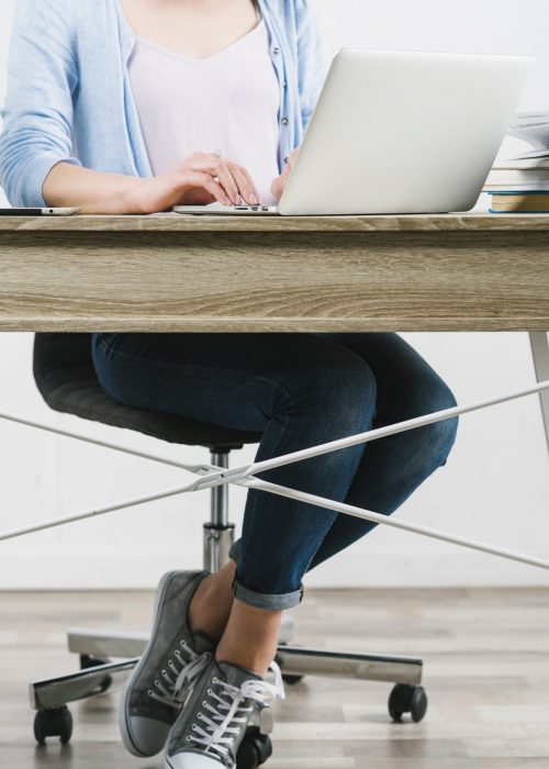 crop-woman-using-laptop-table